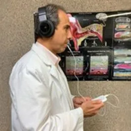 Dr. Danesh demonstrating the Lenire tinnitus treatment device