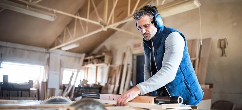 Worker wearing protective earmuffs