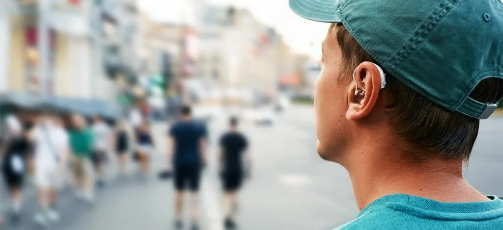 Person adjusting to new hearing aids